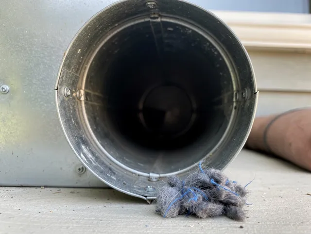 Rocky River Dryer Vent Cleaning technician using specialized equipment to clear severe dryer vent blockage in Rocky River